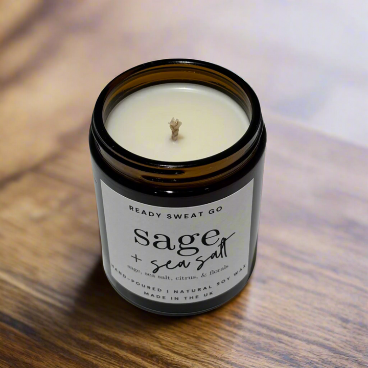 Amber Glass Soy Candle sIts On Polished Wood