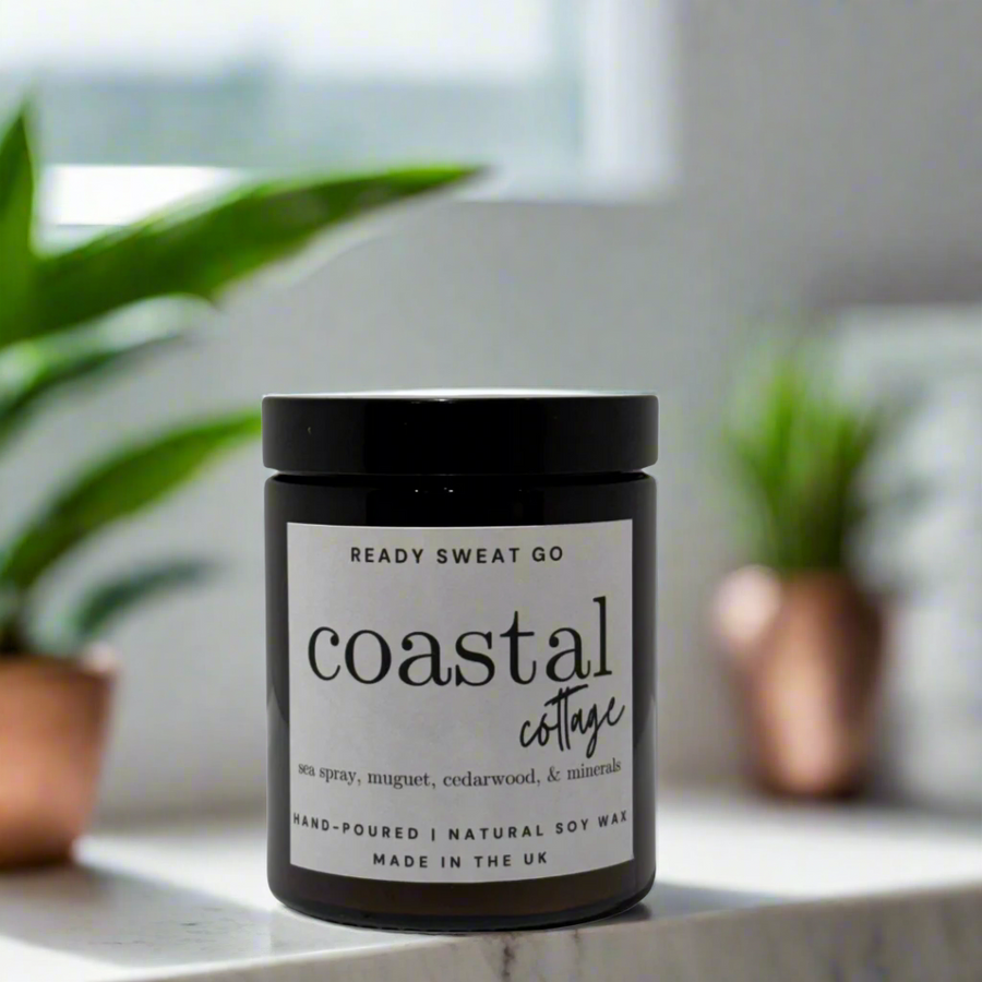 RSG coastal candle in sunlit marble bathroom