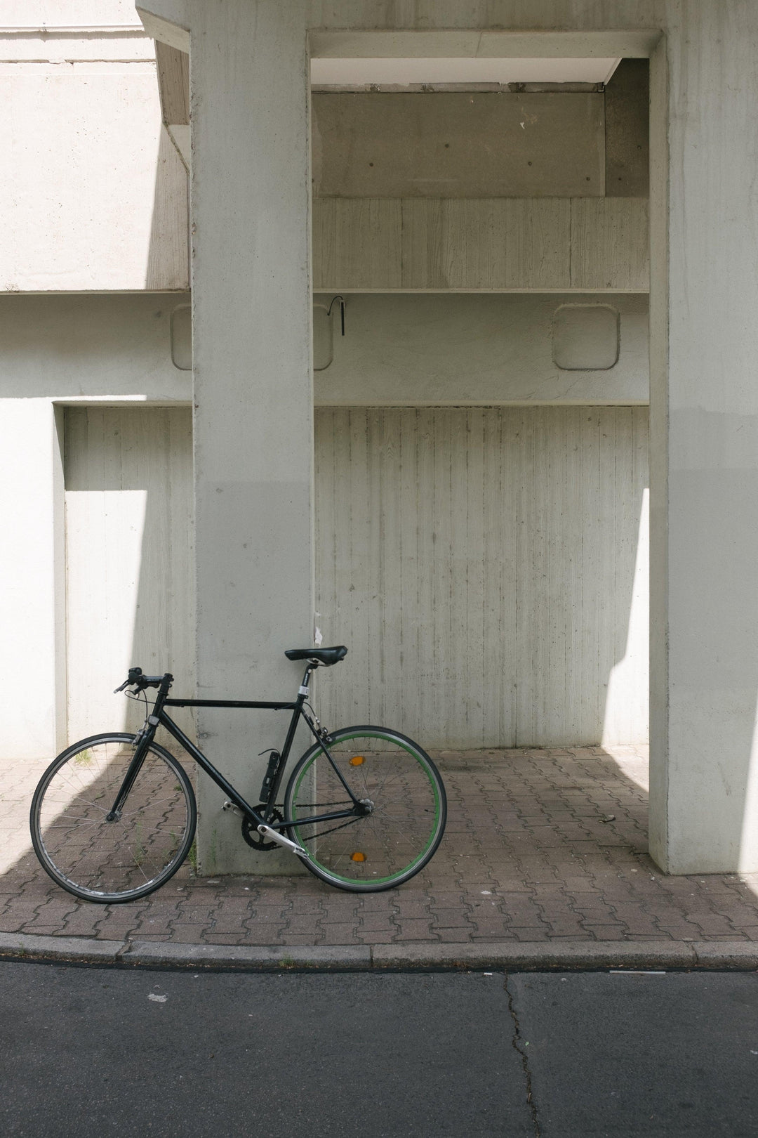 bike-sits-against-concrete-column - Ready Sweat Go