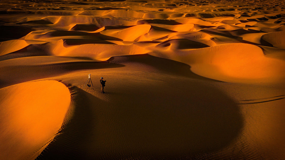 landscape-of-sand-dunes-with-photographer-in-view - Ready Sweat Go