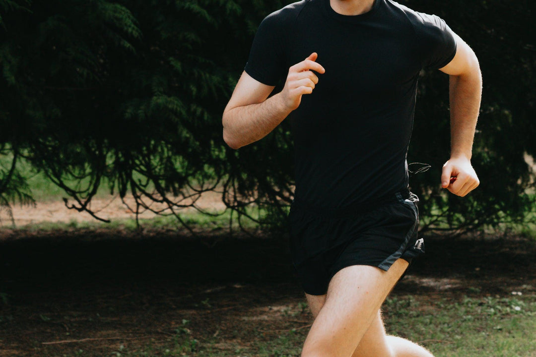 person-in-black-running-in-the-green-outdoors - Ready Sweat Go