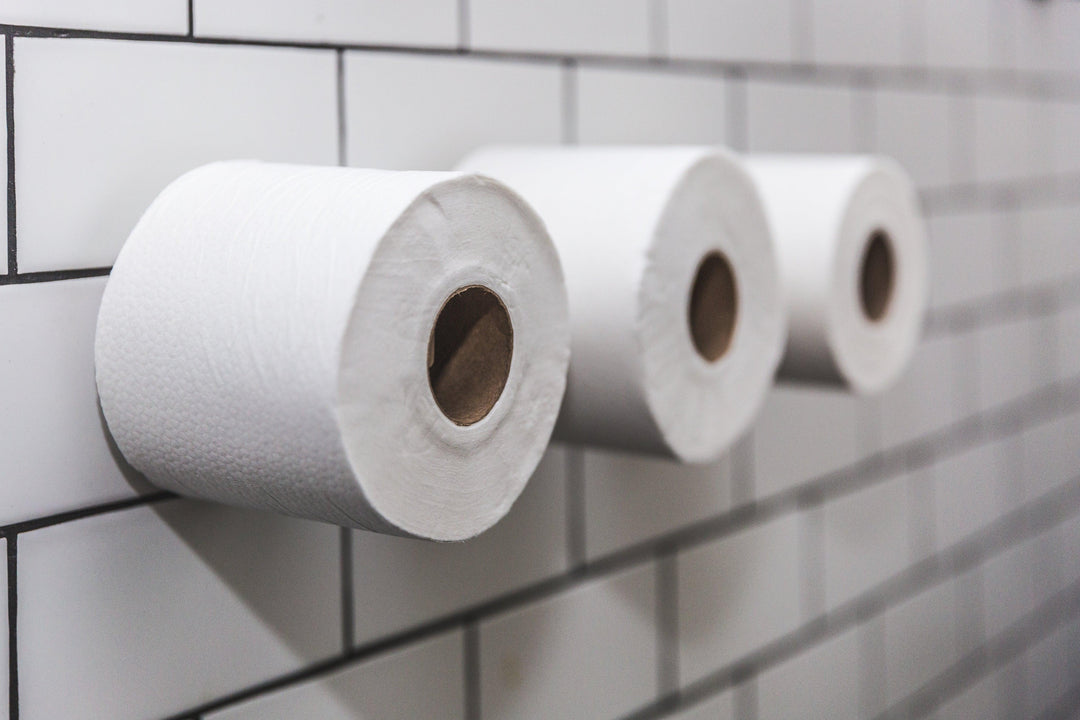 three-rolls-of-toilet-paper-on-white-tile-wall - Ready Sweat Go