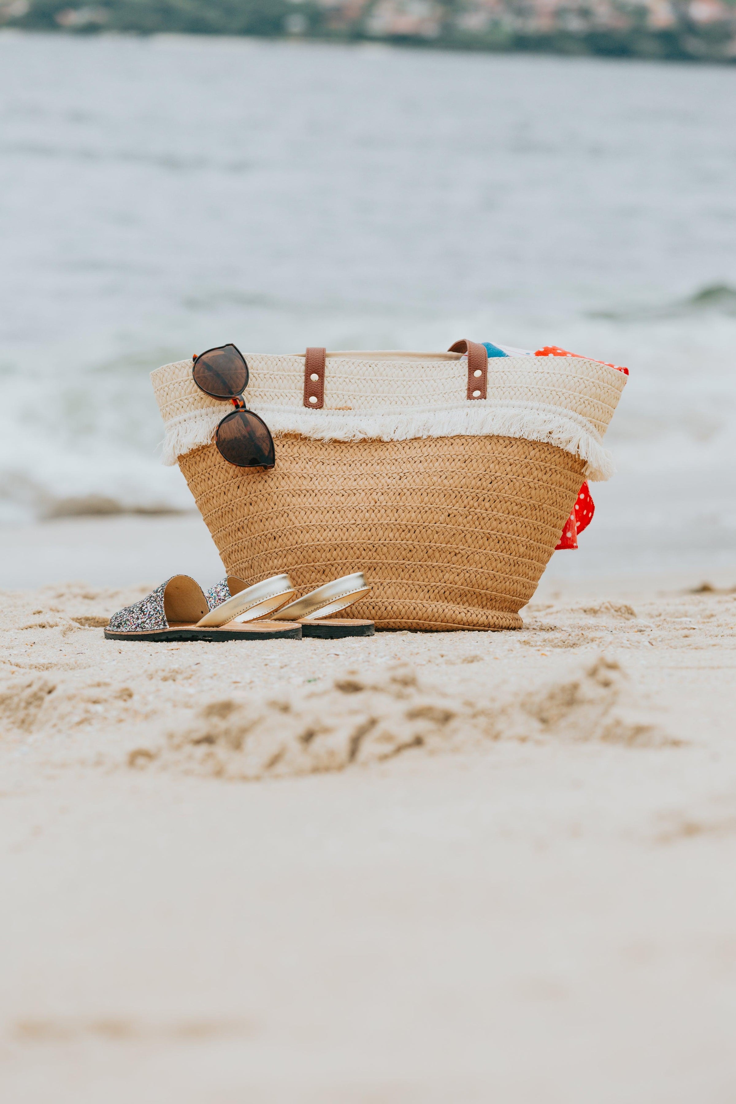wicker-beach-bag-and-sandals-on-a-white-sandy-beach - Ready Sweat Go